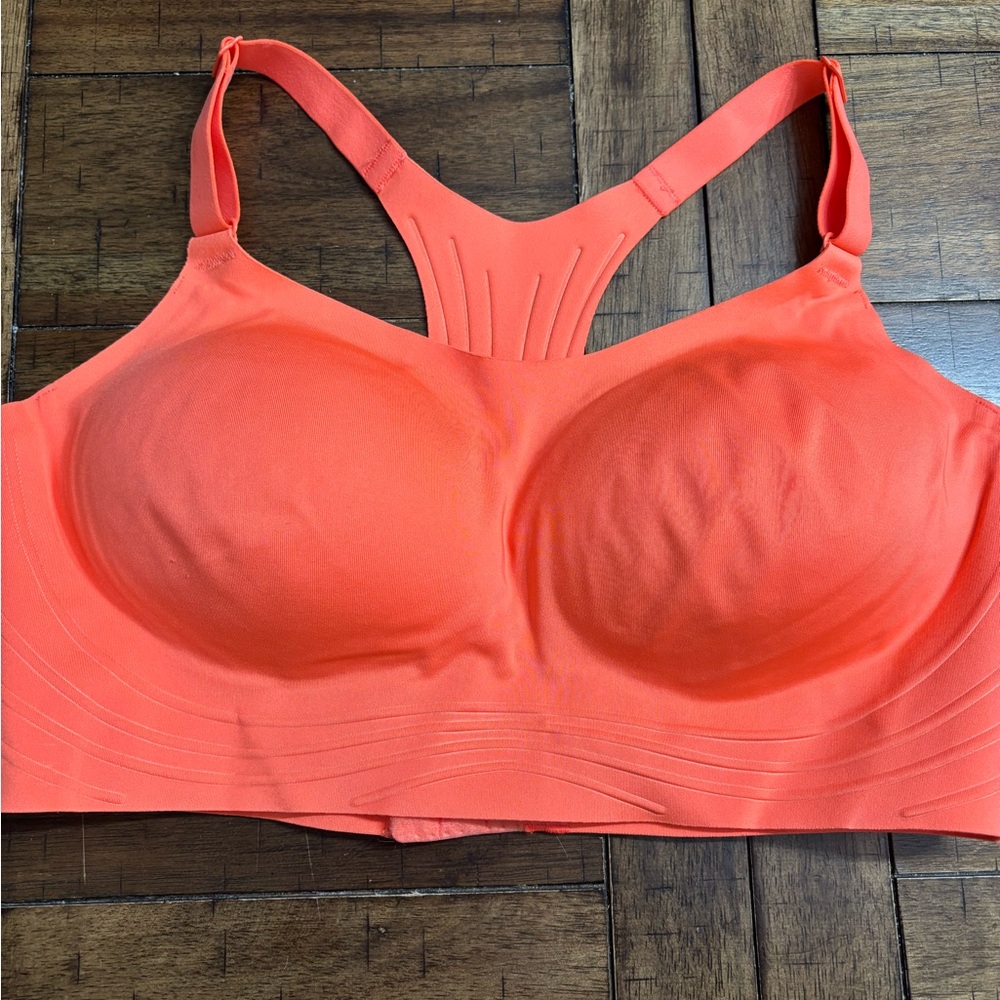 New with tags Women’s coral/orange in color sports bra.